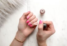 A lady applying nail polish