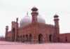 a large red brick building with a white dome