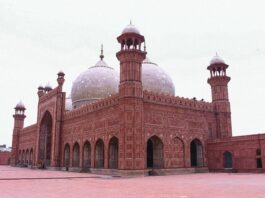 a large red brick building with a white dome