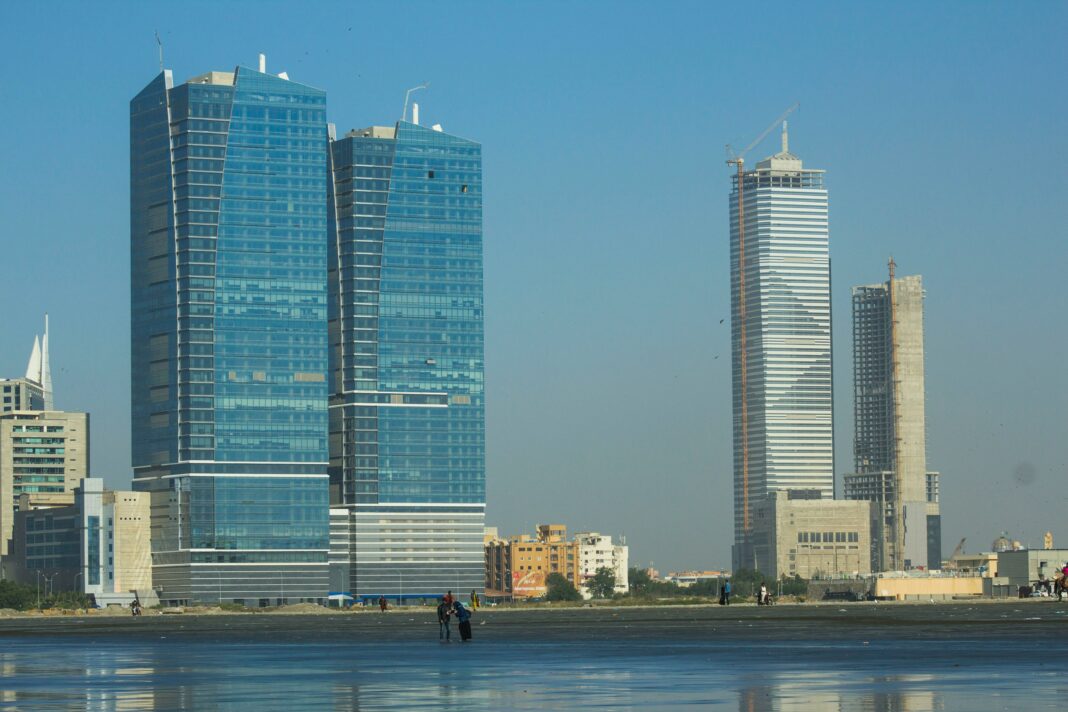 view of a beach with skyscrapers at the back