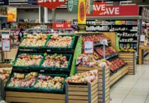 a rack holding vegetables in a supermarket