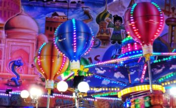 a carnival ride at night with colorful lights