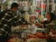 Old But Gold Karachi Oldest Business Still Loved Today man in black and white plaid dress shirt holding white plastic bag