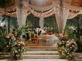 a room filled with lots of table covered in white drapes