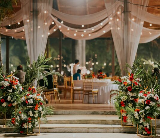 Luxury Wedding Halls in Karachi for a Dream Celebration a room filled with lots of table covered in white drapes