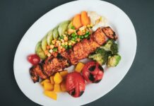 Where To Find The Best Diet Meal Delivery In Karachi grilled meat with sliced lemon and sliced tomatoes on white ceramic plate