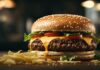 Gourmet double cheeseburger with sesame bun, melted cheddar, beef patties, lettuce and tomato, served with fries